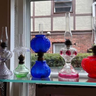 Antique oil lamps, lots of different sizes, from minis to large
