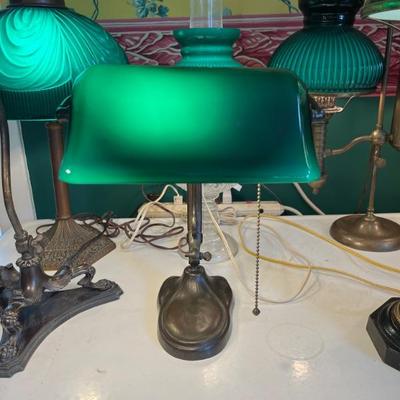 A large selection of antique green case glass lamps and shades, including Handel basesâ€”floor lamps, desk lamps, table lamps