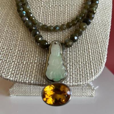 Double strand of faceted green garnets with an antique jade and large topaz pendant set in silver