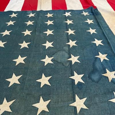 Huge early 48 star American flag, 8â€™ x 15â€™, all stitched with appliquÃ© stars, some minor water stains, c 1912-1917, around 1918...