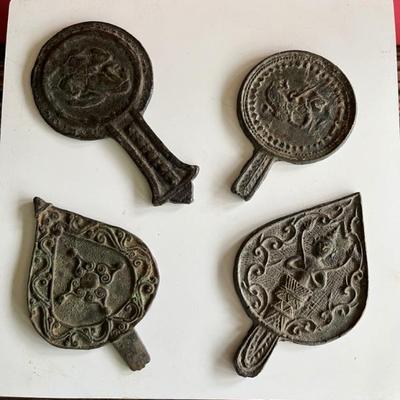 A collection of antique bronze Popil, sacred Khmer ceremonial objects, originating in Cambodia, used during celebrations like weddings or...