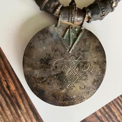 Omani silver pendant on a necklace with large silver beads and two 18th century coins on a thick cord