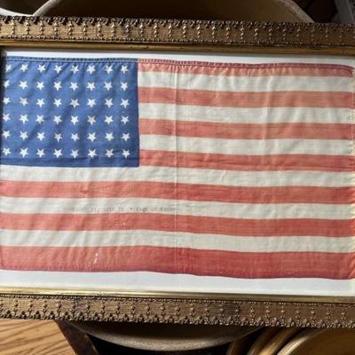 Armistice Day American flag, silk, 48 star, typed onto a white stripe â€œNovember 11, 1918 â€œPeace on Earthâ€ â€œ, framed, WWI