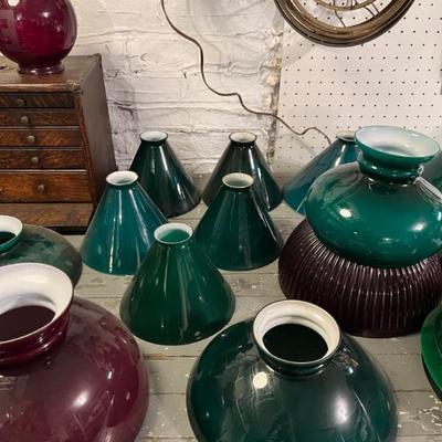 Lots of antique case glass lamp shades in green, milk glass, and red. Do you have an old lamp that needs a period replacement shade?