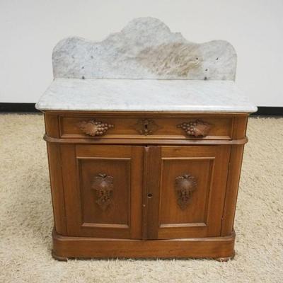 1109	ANTIQUE WALNUT VICTORIAN WASHSTAND, MARBLE TOP W/CARVED GRAPE CLUSTER PULLS, LOSS & REPAIR TO MARBLE TOP, APPROXIMATELY 34 IN X...