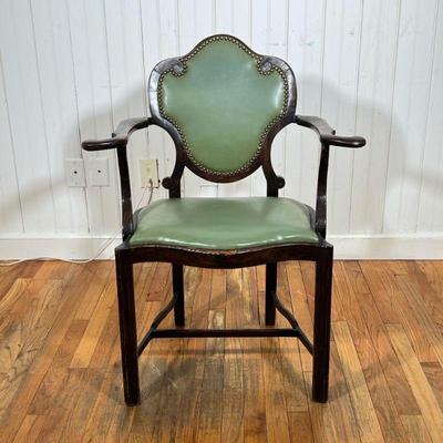 ART NOUVEAU CARVED ARMCHAIR | Having riveted leather back with ornate carved scrolls and curved arms over green leather cushion raised on...
