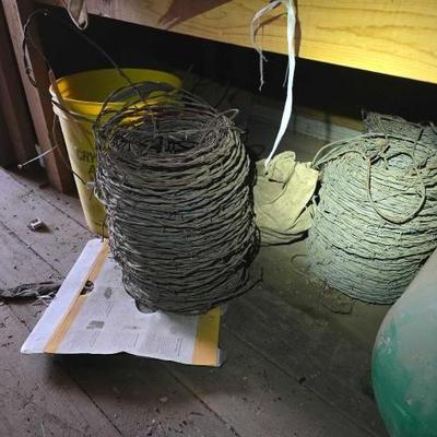 #4038 â€¢ 4 Bundles of Barb Wire and Bucket of Wheels
