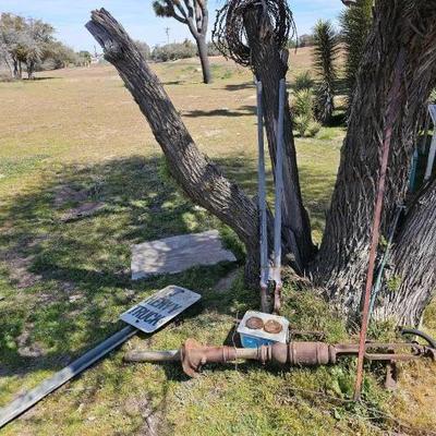#1902 â€¢ Water Pump, Rake, Sign, Razor Wire, and Mini Stove
