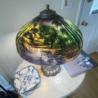 Reverse painted Swans lamp by Pittsburgh lamp company on a silver colored base.  The background coloring is incredible.
