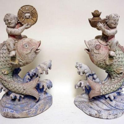 1236	PAIR OF POLYCHROME CARVED WOOD CHINESE FIGURES OF MEN RIDING ON TOP OF FISH, EACH APPROXIMATELY 11 IN X 5 IN X 20 IN H
