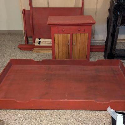 Red twin bed and nightstand