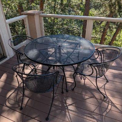 Lot #70 - Black Metal Table Patio Table & Four Chairs With Cushions
