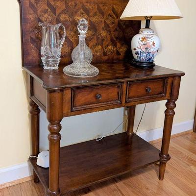 Occasional table with cut crystal items and quality lamp