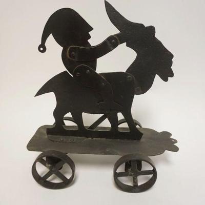 1242	FOLK ART METAL MECHANICAL PULL TOY W/MAN W/CAP RIDING A GOAT, APPROXIMATELY 13 IN X 7 IN X 14 IN HIGH
