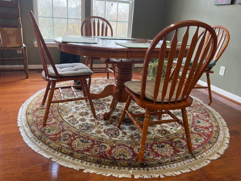 Sunlit dining table and Windsor chairs at an Estate Greats sale in Spring Hill, Tennessee