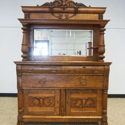 1147	OAK 2 PART MIRROR BACK SIDEBOARD W/TURNED FLUTED COLUMNS, 3 DRAWERS OVER 2 CARVED DOORS, APPROXIMATELY 54 IN X 23 IN X 79 IN HIGH
