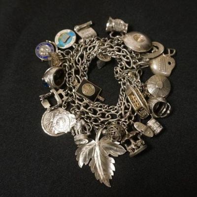 1109	STERLING SILVER CHARM BRACELET, 3.73 TOZ, 5 CHARMS NO MARKINGS FOUND. SOME MARKED MEXICO, APPROXIMATELY 7 IN
