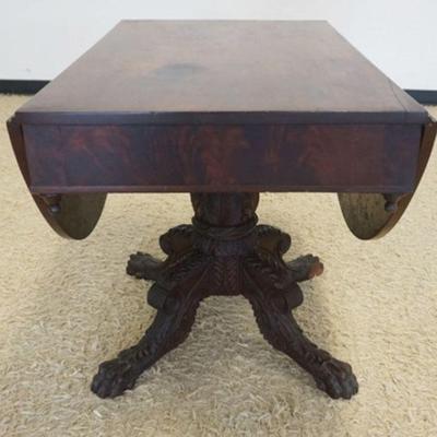 1156	EMPIRE MAHOGANY DROP LEAF TABLE ON HEAVILY CARVED CLAW FOOT AND PEDESTAL BASE, APPROXIMATELY 39  IN X 25 IN X 29 IN H, EACH LEAF...