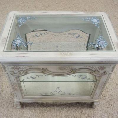 1180	ORNATE SMALL DOUBLE DOOR DISPLAY CABINET WITH BEVELED GLASS, FLORAL DECORATED TOP AND ADJUSTABLE INTERIOR SHELF, APPROXIMATELY 28 IN...
