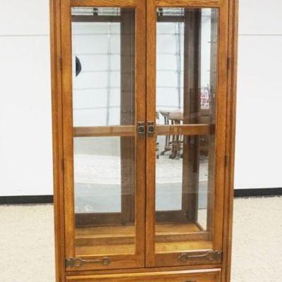 1182	PULASKI OAK 2 DOOR CRYSTAL CABINET WITH LOWER DRAWER AND BEVELED GLASS DOORS WITH SLAG AND ICED GLASS TOP, ADJUSTABLE SHELVES WITH...