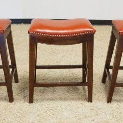 1206	SADDLE SHAPED STOOLS, VINYL WITH BRASS TACK ACCENTS, EACH APPROXIMATELY 21 IN X 14 IN X 25 IN H

