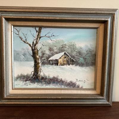 Midcentury style winterscape scene with barn. Signed by the artist Benny C. Measures 18 1/2 x 22 1/2”. $125