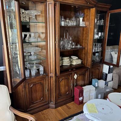 Vintage china cabinet overflowing with unique vintage cake plates, china, crystal and glassware