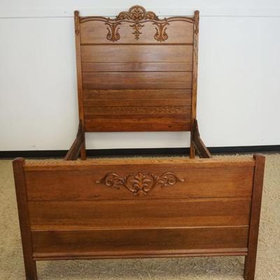 1253	ANTIQUE OAK HIGH BACK BED WITH APPLIED CARVINGS, APPROXIMATELY 57 IN X 77 IN X 75 IN H

