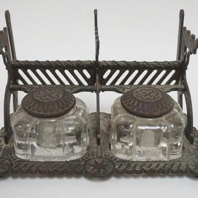 1105	ANTIQUE DOUBLE INKWELL IN ORNATE CAST METAL STAND W/PEN HOLDERS, APPROXIMATELY 10 IN X 5 IN X 6 IN IGH
