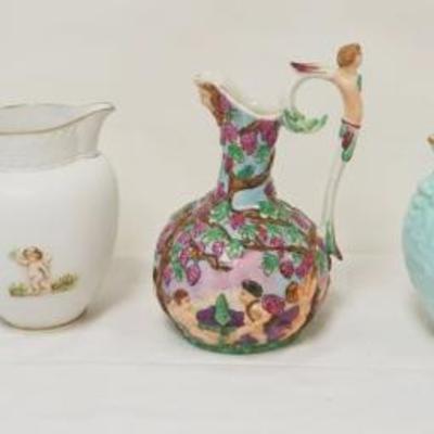 1128	GROUP OF ASSORTED PITCHERS INCLUDING CAPODIMONTI & SEVERAL W/EMBOSSED NEOCLASSICAL DESIGNS, TALLEST APPROXIMATELY 9 IN
