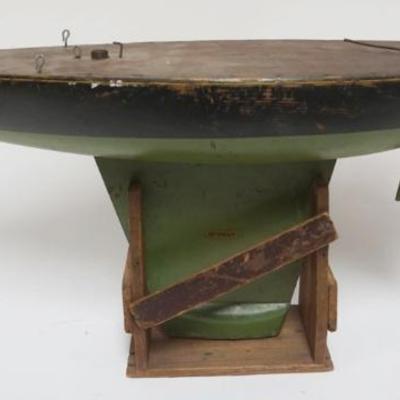 1103	*DEFENDER* BOYS POND BOAT MADE BY SEAWORTHY BOATS IN STAND W/ORIGINAL DECALS, APPROXIMATELY 30 IN X 8 IN X 13 IN HIGH, MISSING MAST...