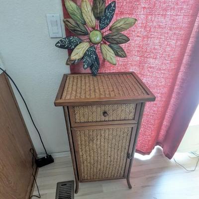 Lot #32 - Vintage Woven Rattan End Table with Decorative Metal Flower Wall Art