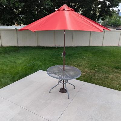 Lot #304 - Red 8ft Patio Tilt Umbrella with Metal Base and Round Table