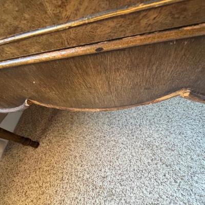 Small pieces of wood detail missing. Could possibly be located in/on the piece. 