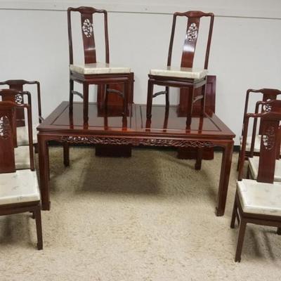 1260	CARVED ASIAN DINING TABLE AND CHAIRS WITH 2 LEAVES, CHAIRS HAVE PIERCED CARVED BENTWOOD BACKS AND UPHOLSTERED SEATS. TABLE HAS...