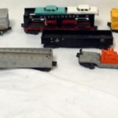 1100	GROUP OF ASSORTED LIONEL O GUAGE TRAIN CARS AND SANTA FE ENGINE
