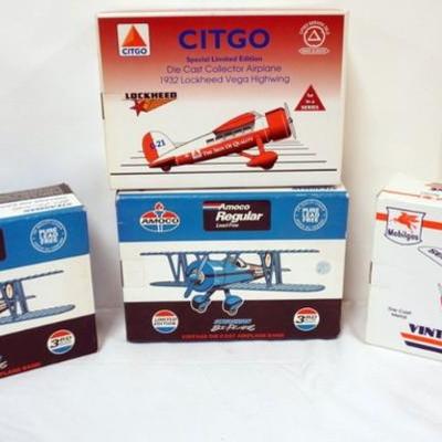 1105	4 DIE CAST AIRPLANE COIN BANKS IN ORGINAL BOXES
