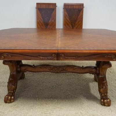 1255	OAK DINING TABLE WITH BOOK MATCHED VENEER TOP, CARVED SKIRT, CARVED PAW FEET WITH GILT ACCENTS, AND 2 LEAVES, TABLE APPROXIMATELY 78...