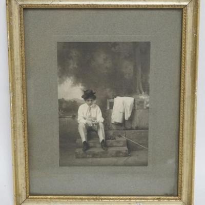1118	ANTIQUE FRAMED PHOTO OF WOMAN DRESSED LIKE A MAN W/HAT, SHIRT & TIE SMOKING A CIGARETTE, APPROXIMATELY 9 1/2 IN X 11 IN OVERALL
