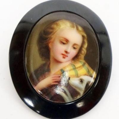 1132	PAINTED CENTER PORCELAIN BROACH, IMAGE OF WOMAN & HER DOG, APPROXIMATELY 1 3/4 IN X 2 IN
