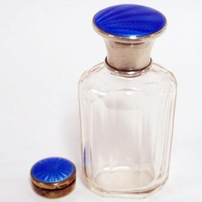1162	CUT GLASS PERFUME WITH SILVER AND ENAMEL LID AND SMALL SILVER 935 ENAMEL TOP BOX, PERFUME APPROXIMATELY 4 IN H
