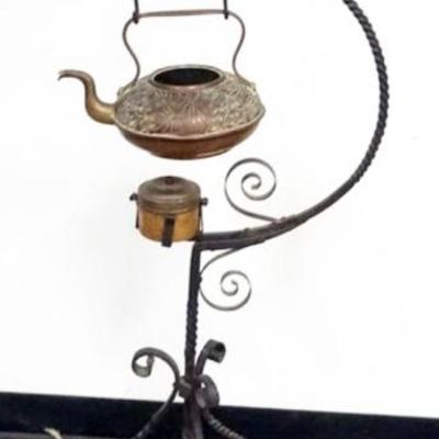 1217	ASIAN TEA POT AND WARMER ON A WROUGHT IRON STAND, TEA POT MISSING LID, APPROXIMATELY 48 IN H
