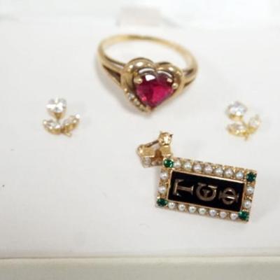 1170	10K GOLD ASSORTED JEWELRY INCLUING CZ FLOWER EARRINGS, RED HEART STONE RING APPROXIMATE SIZE 9 1/4 AND FRATERNITY PIN WITH STONES
