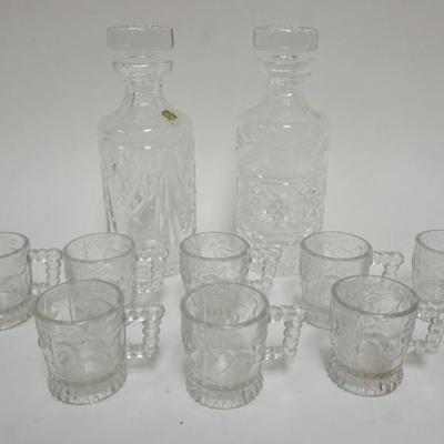 1124	PAIR OF WATERFORD CRYSTAL DECANTORS AND 8 ANTIQUE EMBOSSED CHILDS MUGS WITH IMAGES OF DOGS AND BIRDS
