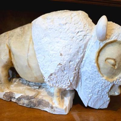 Large carved natural stone bison.