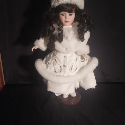 Sale Photo Thumbnail #449: MEASURES 16" TALL AND COMES WITH STAND. WINTER THEMED OUTFIT WITH FUR TRIMMED COAT, MATCHING HAT AND PEARL LIKE ACCENTS