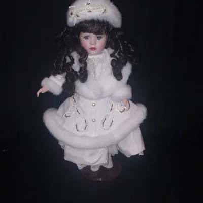Sale Photo Thumbnail #452: MEASURES 16" TALL AND COMES WITH STAND. WINTER THEMED OUTFIT WITH FUR TRIMMED COAT, MATCHING HAT AND PEARL LIKE ACCENTS