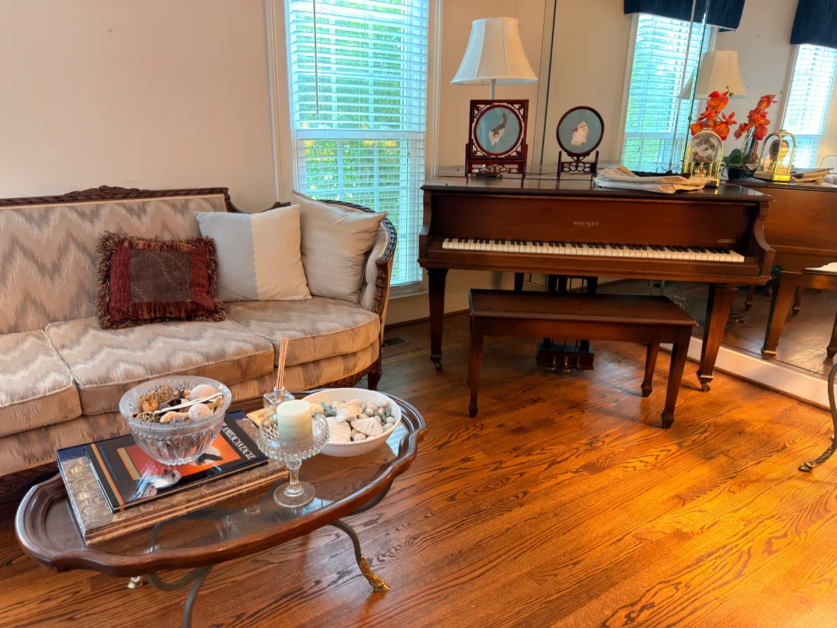 Staged living room with a piano at an Estate Greats sale in Brentwood, Tennessee