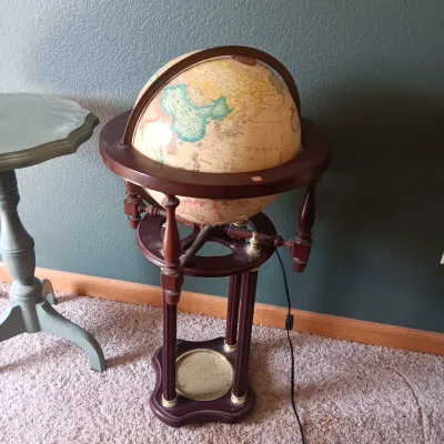 LIGHTED GLOBE ON A STAND, WORLD MAP ON CANVAS AND A SIDE TABLE