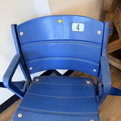 Sale Photo Thumbnail #34: Original blue stadium seat #4 from Veterans Stadium, former home of the Philadelphia Phillies and Eagles. Features molded plastic seat and back with heavy-duty metal frame/supports and metal seat number plate. Includes Certificate of Authenticity signed b